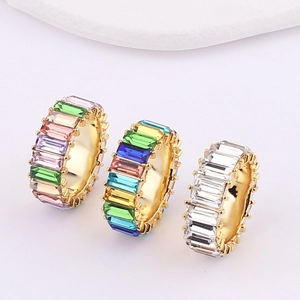 Detailed top view of gold plated eternity rings with colorful and white zircon crystals