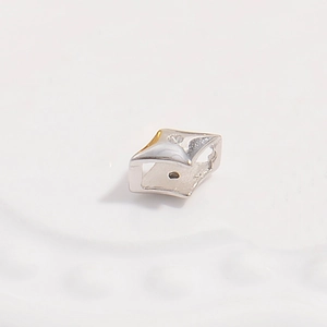 Macro shot of S925 silver rhombic bead spacer with sparkling zircon for DIY jewelry