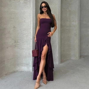 Detail of elegant dark purple strapless long dress featuring ruffled hem and side high slit
