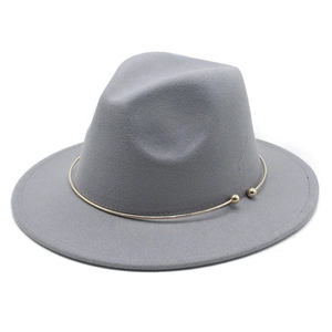 Detail of grey wool fedora hat featuring a stylish gold metal ring and spherical accents