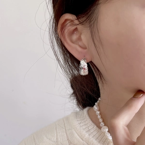 Close-up of minimalist 925 sterling silver hammered hoop earring worn by a model