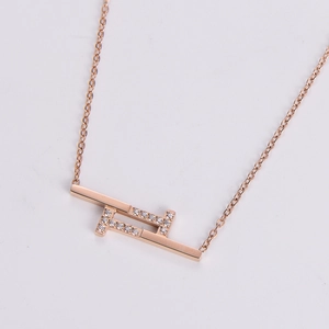 Macro detail of rose gold geometric necklace with sparkling white zircon inlay