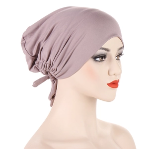 Detail view of mauve satin-lined drawstring hijab cap with pleated back and ties
