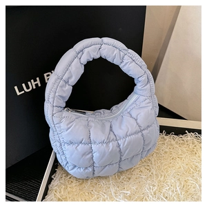 Detail shot of light blue quilted cloud bag showing puff texture and grid stitching