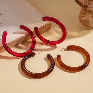 Chic resin C-shape hoop earrings in deep red and tortoiseshell patterns on vintage books