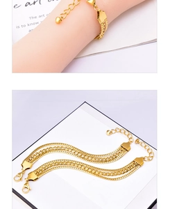 Detail of gold multi-layered snake chain bracelet with adjustable lobster clasp and polished finish