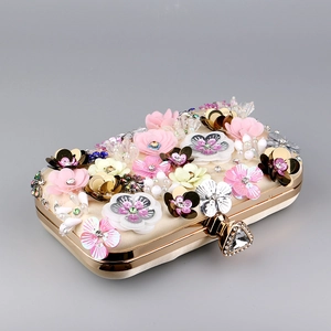 Detail of handmade beaded floral clutch with sparkling crystal triangle metal clasp