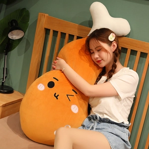Close-up of a large fried chicken leg plush pillow with cute cartoon face embroidery