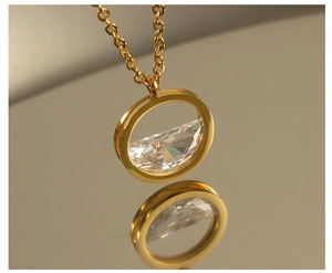 Macro shot of 18K gold stainless steel necklace with round crystal heart pendant