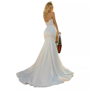 Elegant white mermaid wedding dress with lace bodice, open back, and long satin train