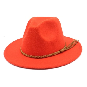 Detailed view of red wool fedora hat with brown braided tassel band decoration