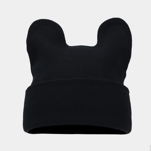 Detail of black knitted beanie with cute bear ears and ribbed cuff texture