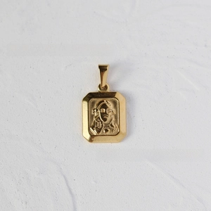 Detail of 18K gold plated stainless steel rectangular pendant with religious relief