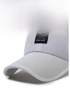 Detailed close-up of white mesh baseball cap featuring breathable fabric and Mountain logo