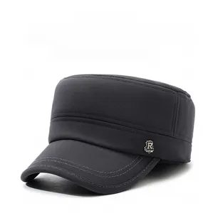 Detail view of winter flat top cap with ear flaps, fine texture and metal R logo