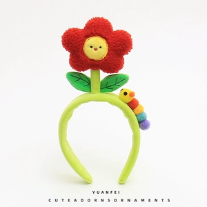 Cute green plush headband with large red flower and colorful caterpillar toy for girls