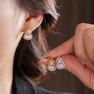 Luxurious gold-plated gourd stud earrings with pavé-set zircon crystals in two colors