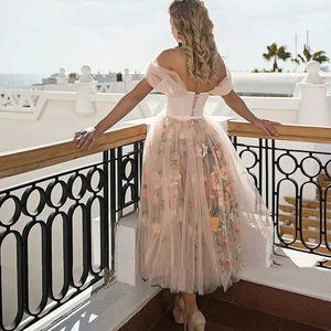 Pink off-shoulder midi dress with floral embroidery and lace-up back detail