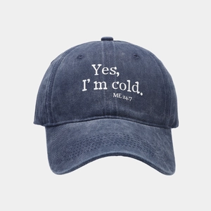 Close-up of 'Yes, I'm cold' letter printing on washed navy cotton baseball cap fabric
