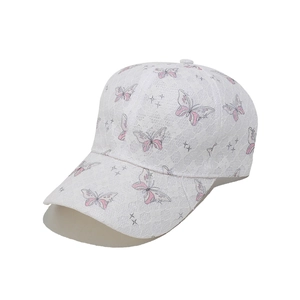 Close-up of white mesh lace baseball cap featuring pink butterfly patterns and star details
