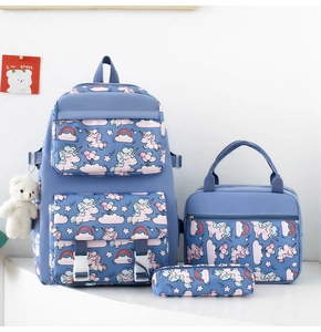 Three-piece blue school backpack set with unicorn patterns and white bear charm detail