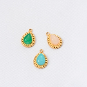 Three bohemian teardrop natural stone pendants in green, pink, and teal with gold frames