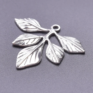 Macro detail of leaf pendant showing silver finish and intricate vein texture