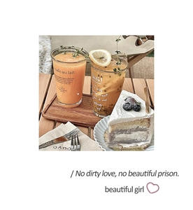 Close-up of elegant clear glass cup and wooden tray during an afternoon tea setting