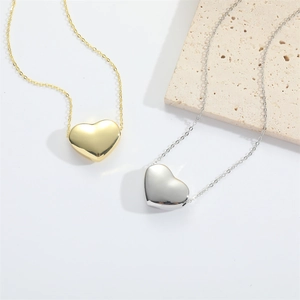 Minimalist polished 3D heart pendant necklaces in gold and silver finish on stone