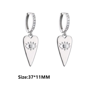 Detailed view of silver heart drop earrings with micro-pave zircon and evil eye motif