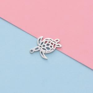 Detailed view of silver hollow turtle charm in polished stainless steel for DIY jewelry