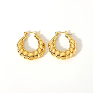 Detailed view of 18K gold plated croissant hoop earrings with a twisted texture design