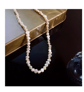 Detailed view of baroque freshwater pearls with natural luster on a gold surface