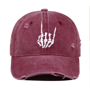 Close-up of skeleton hand embroidery and distressed detail on washed cotton baseball cap