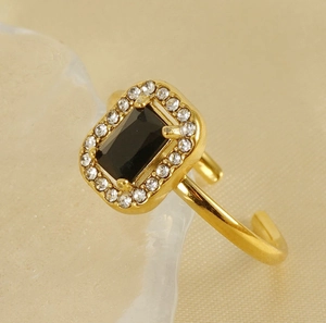 Macro detail of 18K gold plated ring featuring a black square zircon and pavé setting