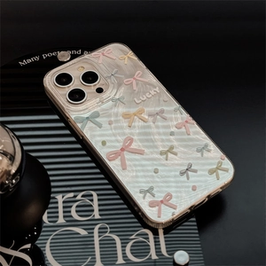 Detail of translucent pearlescent iPhone case with colorful bows and Lucky lettering