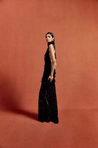 Detailed view of the intricate floral lace texture on this elegant black evening gown
