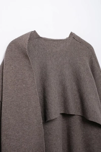 Detailed close-up showing the layered back design and soft knit texture of the brown coat