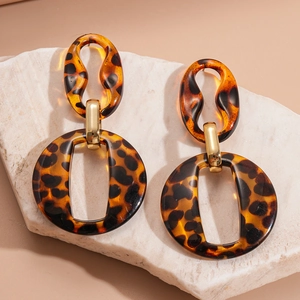 Chic leopard print acrylic geometric hoop earrings with elegant gold accents on a stone
