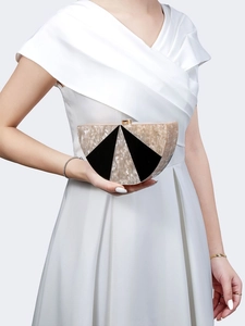 Detail of marble pattern acrylic half-moon clutch with golden clasp for evening wedding