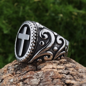 Vintage stainless steel mens cross ring with gothic floral relief on tree bark background
