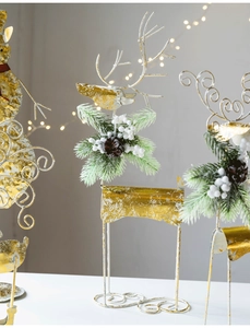 Detailed view of metal Christmas reindeer with festive pine needles and pinecones decor