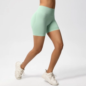 Detail view of seamless high waisted mint green gym shorts with wide compression waistband