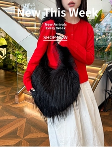 Chic black faux fur oversized shoulder bag with long plush fibers worn by a female model