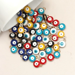 Macro detail of colorful 8mm Evil Eye pendants with gold plating for DIY jewelry making
