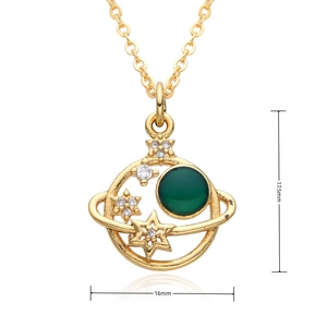 Detailed close-up of 18k gold planet pendant with green gem and white crystals