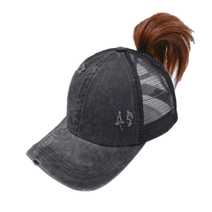 Detail of washed grey ponytail baseball cap with distressed finish and breathable mesh