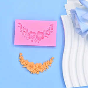 Macro detail of pink silicone flower mold with intricate vine textures for cake decorating