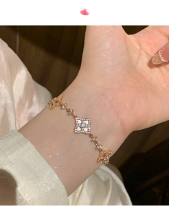 Detail of rose gold clover bracelet with white shell inlays and sparkling zircons