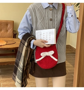 Retro red plush bucket bag with white bow detail shown in a vintage lifestyle setting